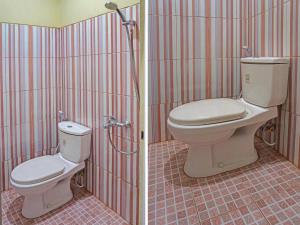 a bathroom with a toilet and a shower at OYO 91649 Orange Homestay Makassar in Makassar