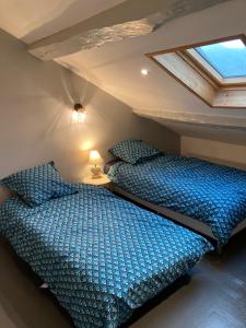 Voodi või voodid majutusasutuse Maison en pierre de70 m2 au cœur d’un hameau toas