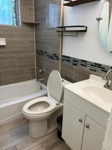 a bathroom with a toilet and a sink at Amazing 1bd apartment with big office in Los Angeles