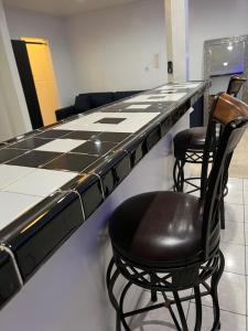 a black and white counter with two chairs and a table at Amazing 1bd apartment with big office in Los Angeles
