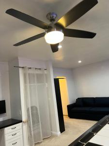 a living room with a ceiling fan and a couch at Amazing 1bd apartment with big office in Los Angeles