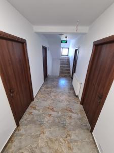 an empty hallway with two doors and a staircase at king in Baile Felix