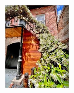 a staircase leading to a building with a balcony at Be Our Gaston's "The Garden of Good" in Savannah