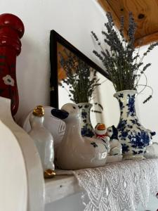 a shelf with vases and rubber ducks on it at Holiday Home Amila in Visoko