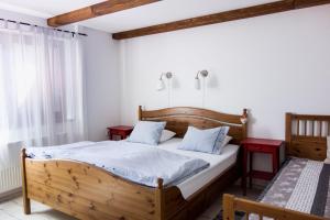 a bedroom with a wooden bed and two red tables at u Jaňola in Oščadnica