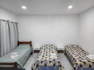 a room with three beds in a room at Monoambiente en el centro de la Ciudad. in Mercedes