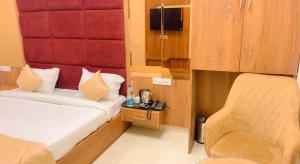 a small room with a bed and a chair at City View With Garden -5 Mins Walk From GOLDEN TEMPLE in Amritsar