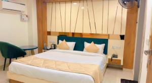 a bedroom with a large bed with a blue headboard at City View With Garden -5 Mins Walk From GOLDEN TEMPLE in Amritsar