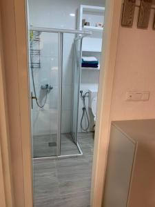 a glass shower in a bathroom with a toilet at Apartmani Šišava apt "HARMONY" Vlašić in Vlasic