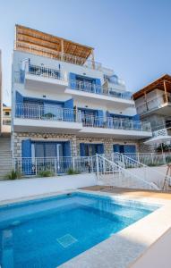 a building with a swimming pool in front of a building at Greek Beach House A3 Lefkada in Nydri