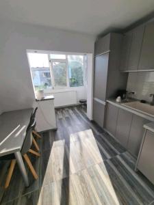 a kitchen with a table and a counter top at Alesandru apartament in Piteşti +8 photos
