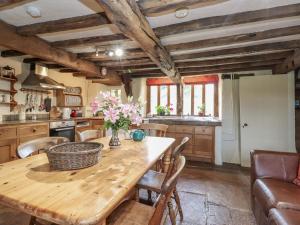 a kitchen with a wooden table and chairs at Ona Ash in Penrith