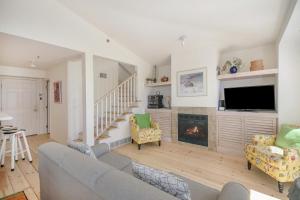 a living room with a couch and a fireplace at Hoopdee Scootee Suite in Saugatuck