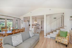 a living room with a couch and a dining room at Hoopdee Scootee Suite in Saugatuck