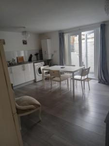 a kitchen and dining room with a table and chairs at 29a Margate in Kent
