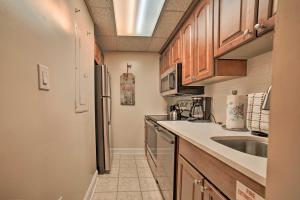 a kitchen with a sink and a refrigerator at Gatlinburg Condo with Smoky Views Walk to Town! in Gatlinburg