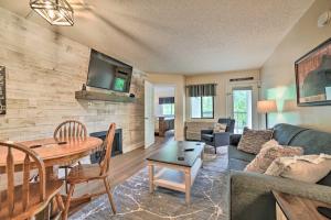 a living room with a couch and a table at Gatlinburg Condo with Smoky Views Walk to Town! in Gatlinburg