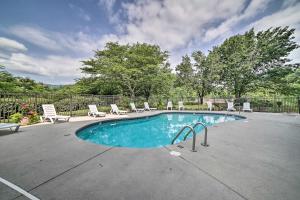 a large swimming pool with chairs at Gatlinburg Condo with Smoky Views Walk to Town! in Gatlinburg