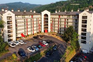 an aerial view of a building with cars parked in a parking lot at Gatlinburg Condo with Smoky Views Walk to Town! in Gatlinburg