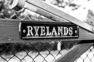a sign on a bench with the word reynolds at Mrs Hortons Guest Rooms in Sutterton
