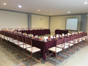 una gran sala de conferencias con una mesa larga y sillas en Hotel Ángel Inn en Oaxaca de Juárez