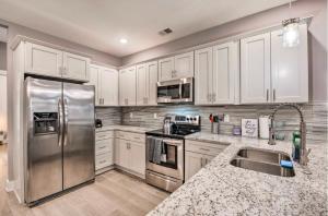 a kitchen with white cabinets and a stainless steel refrigerator at Cozy 4 bedroom Located right downtown ATL in Atlanta