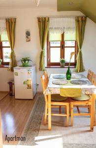 a dining room with a table and chairs and a refrigerator at Výprachtice L.V. in Výprachtice