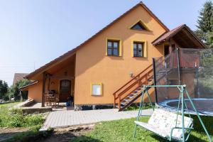 a house with a playground in front of it at Výprachtice L.V. in Výprachtice