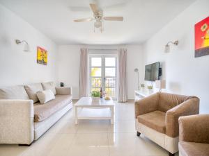 a living room with two couches and a tv at Marina nº 5 in Puerto de Mogán