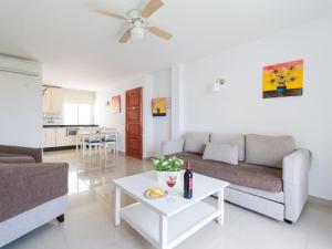 a living room with a couch and a table at Marina nº 5 in Puerto de Mogán