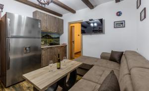 a living room with a couch and a refrigerator at Luxury House Lotos in Golubovci +14 photos