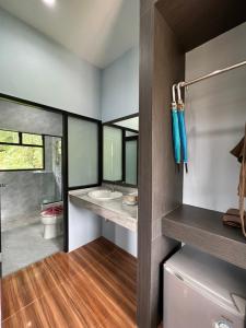 a bathroom with a sink and a toilet in a room at Khaosok Rainforest Resort in Khao Sok