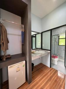 a bathroom with a tub and a sink and a toilet at Khaosok Rainforest Resort in Khao Sok