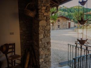 a view of a street from a stone building with a chair at Locanda del Daino in Lemmi