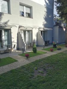 a courtyard of a building with tables and chairs at Bowal in Grzybowo