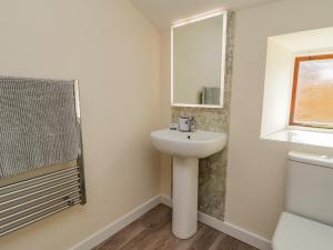 a bathroom with a sink and a mirror at Raygill Cottage in Whitby +16 photos