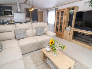 a living room with a couch and a table at Chantry Lodge in Newquay