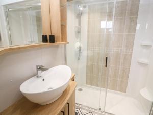 a bathroom with a white sink and a shower at Chantry Lodge in Newquay +25 photos