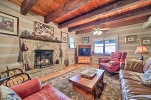a living room with a fireplace and a tv at Bryson City Cabin with Hot Tub about 10 Mi to Dtwn! in Lauada