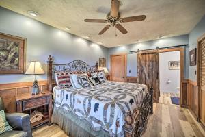 a bedroom with a bed and a ceiling fan at Bryson City Cabin with Hot Tub about 10 Mi to Dtwn! in Lauada