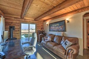 a living room with a couch and a table at Stunning Driggs Retreat with Private Hot Tub and Pond! in Driggs