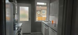 a kitchen with a sink and a window at Three Bedroomed House in Morecambe in Morecambe