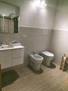 a bathroom with a toilet and a bidet and a sink at Appartamento Hygge incantevole in Reggio di Calabria