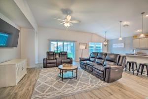 a living room with leather furniture and a kitchen at Home with Lanai and Golf Cart in The Villages in Wildwood