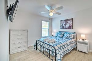 a bedroom with a bed and a ceiling fan at Home with Lanai and Golf Cart in The Villages in Wildwood