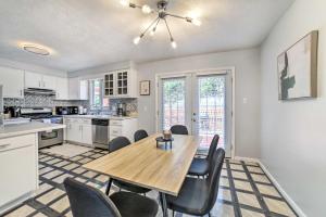 a kitchen and dining room with a wooden table and chairs at Pittsburgh Retreat with Deck about 4 Mi to Dtwn! in Pittsburgh
