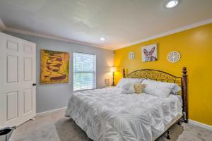 a bedroom with a large bed with yellow walls at Cozy Waldorf Guest Suite Near Potomac River! in Waldorf