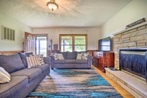 a living room with two couches and a fireplace at McArthur Cabin Peaceful Getaway on Farm! in Stella