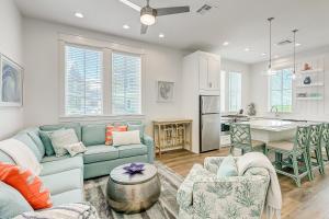 a living room with a blue couch and a kitchen at Beach Days & Fairways in Port Aransas