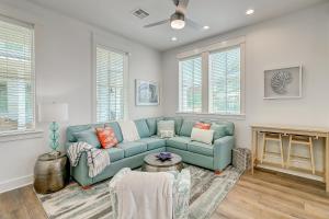 a living room with a blue couch and a fireplace at Beach Days & Fairways in Port Aransas